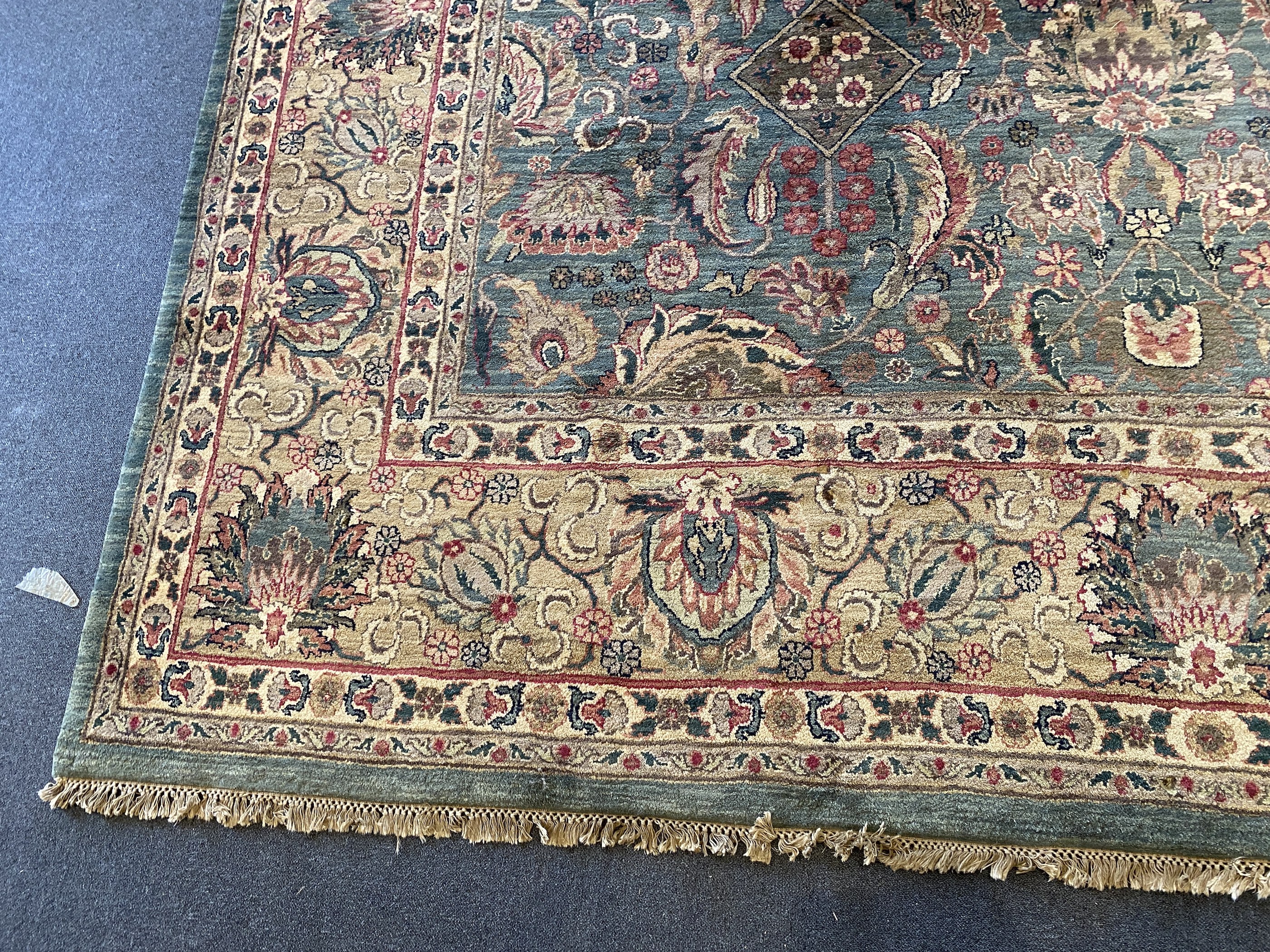 An Indian Persian style sage green ground carpet, 465 x 363cm